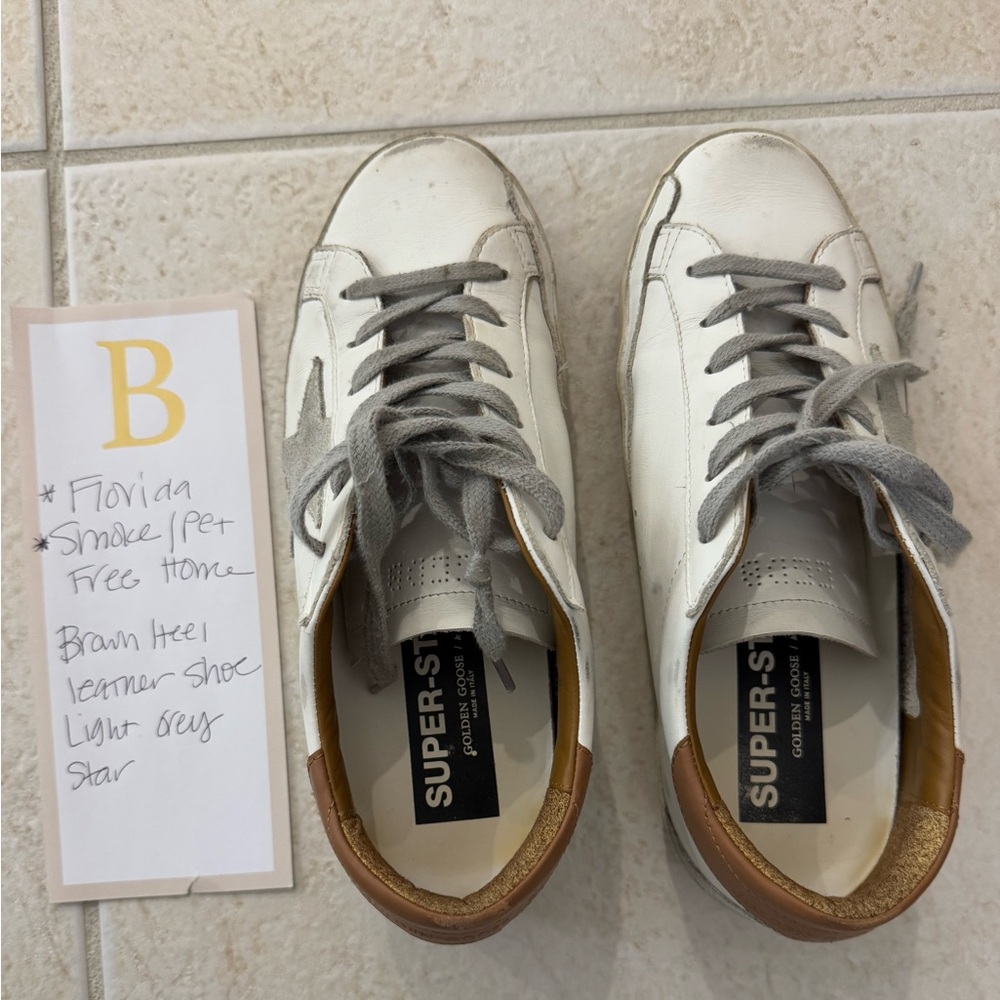 White leather golden goose. Size 38. 
Tan heel; grey neutral star. Comes w box.